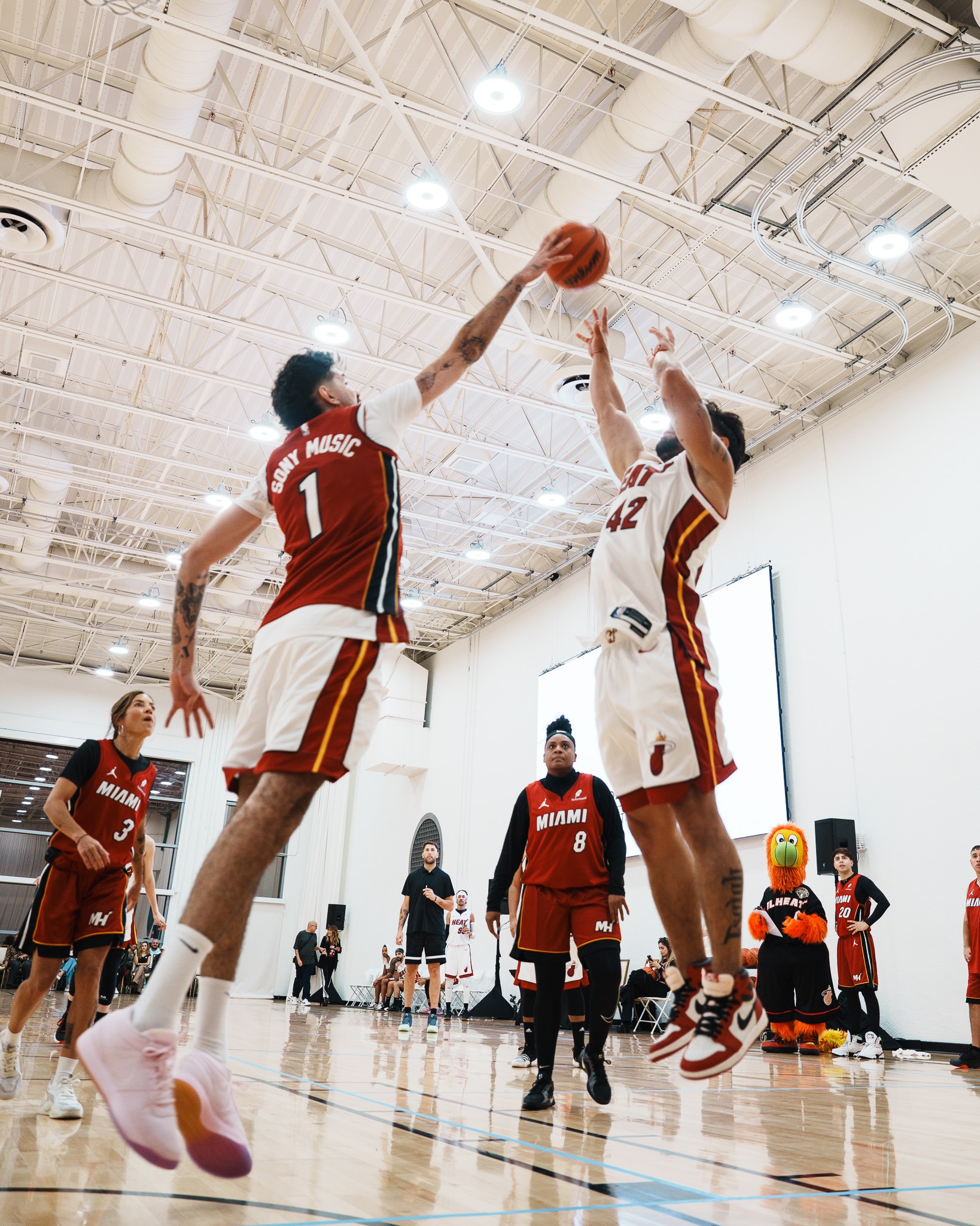 Two players contesting a jump shot during the Sony Music Celebrity Game
